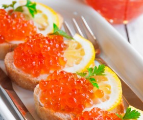 Red caviar on bread with lemon and parsley Stock Photo 04