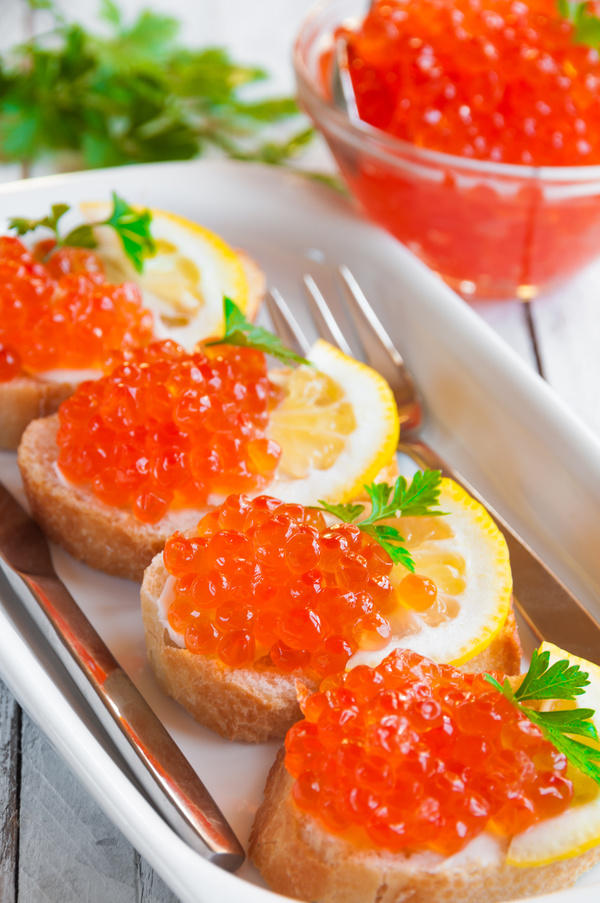 Red caviar on bread with lemon and parsley Stock Photo 04