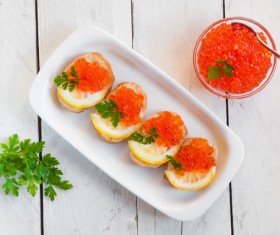 Red caviar on bread with lemon and parsley Stock Photo 06