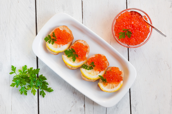 Red caviar on bread with lemon and parsley Stock Photo 06