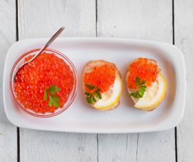 Red caviar on bread with lemon and parsley Stock Photo 07