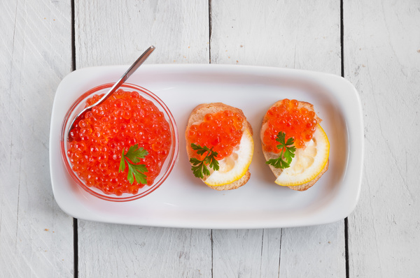 Red caviar on bread with lemon and parsley Stock Photo 07