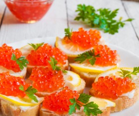 Red caviar on bread with lemon and parsley Stock Photo 08