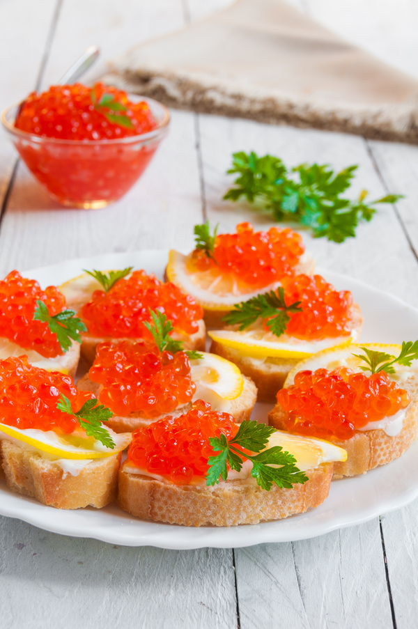 Red caviar on bread with lemon and parsley Stock Photo 08