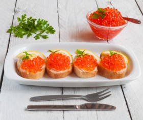 Red caviar on bread with lemon and parsley Stock Photo 09