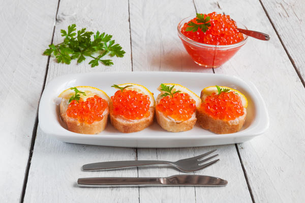Red caviar on bread with lemon and parsley Stock Photo 09