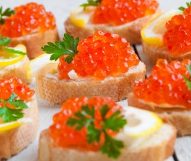 Red caviar on bread with lemon and parsley Stock Photo 11