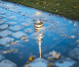 Reflection of tower architecture on water puddle Stock Photo