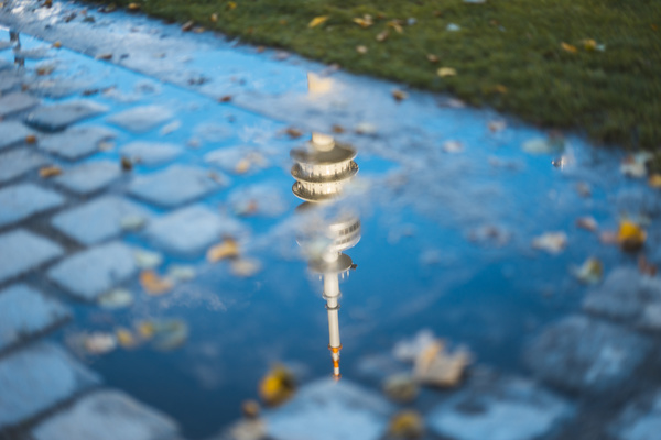 Reflection of tower architecture on water puddle Stock Photo