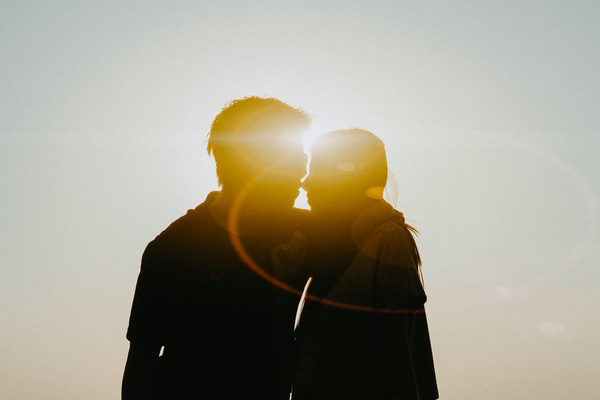 Romantic couple posing under sunlight Stock Photo