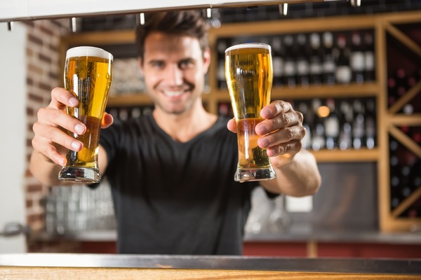 Serving waiter with beer Stock Photo