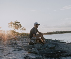 Sitting alone by the river man Stock Photo