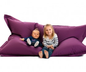 Sitting on inflatable chair siblings Stock Photo