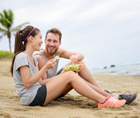 Sitting on the beach eating salad lovers Stock Photo