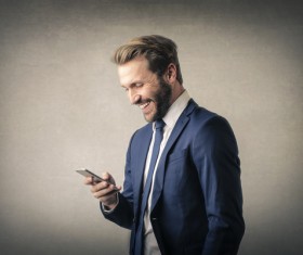 Smiling man seeing cell phone information Stock Photo