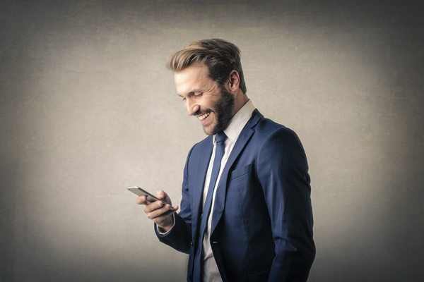 Smiling man seeing cell phone information Stock Photo