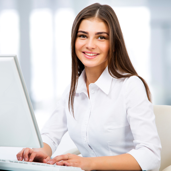 Smiling woman using computer Stock Photo 01