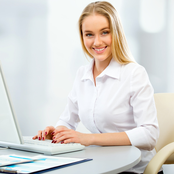 Smiling woman using computer Stock Photo 02