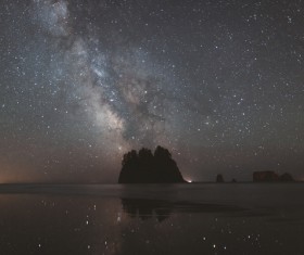 Sparkling starry sky above calm sea Stock Photo