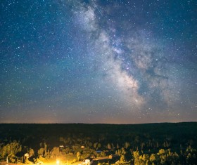 Sparkling starry sky above forest Stock Photo