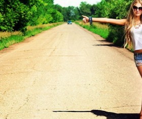 Stylish girl hitchhiking Stock Photo