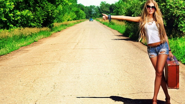 Stylish girl hitchhiking Stock Photo