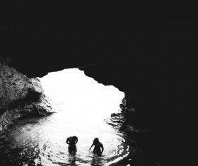 Swimming in a cave people Stock Photo