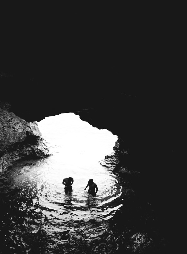 Swimming in a cave people Stock Photo