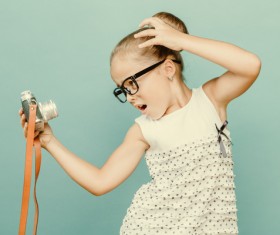 The little girl holding a camera selfie Stock Photo