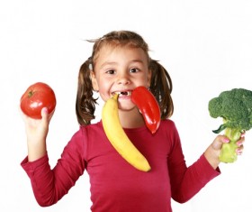 The little girl holding fruit and vegetables Stock Photo