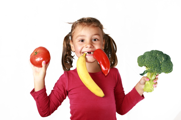 The little girl holding fruit and vegetables Stock Photo