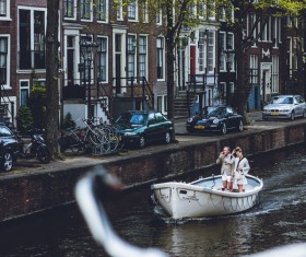 Tourists enjoy boating on river in city Stock Photo