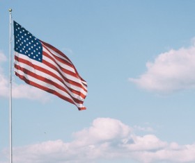 Usa flag waving on cloud sky Stock Photo