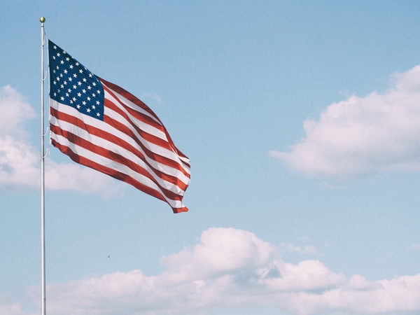 Usa flag waving on cloud sky Stock Photo