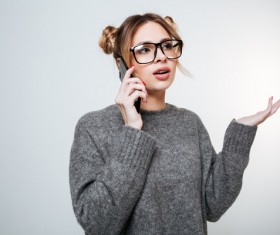 Wearing broad-brimmed glasses girl answered the phone Stock Photo