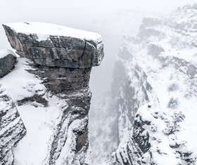 White snow covering high rocky mountain range Stock Photo