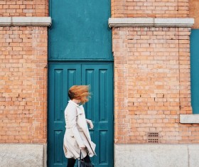 Wind blowing woman hair on road Stock Photo