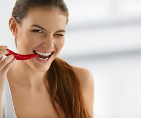 Woman eating red pepper Stock Photo