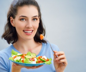 Woman eating salad mixed vegetables Stock Photo 02