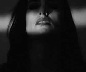 Woman face in darkness Stock Photo