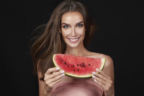 Woman holding a slice of watermelon Stock Photo