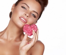 Woman holding heart shaped candy Stock Photo