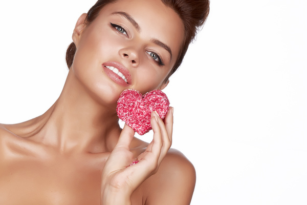 Woman holding heart shaped candy Stock Photo