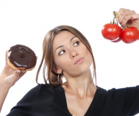 Woman holding tomatoes and cake Stock Photo