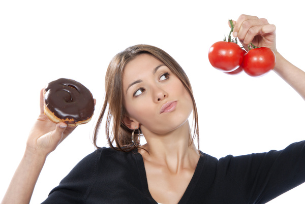Woman holding tomatoes and cake Stock Photo