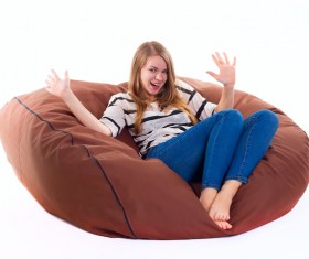 Woman sitting in inflatable chair Stock Photo