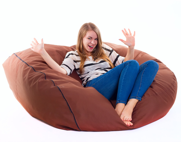 Woman sitting in inflatable chair Stock Photo