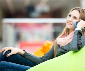 Woman sitting in inflatable chair and phoning Stock Photo