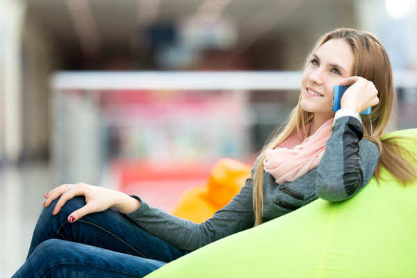 Woman sitting in inflatable chair and phoning Stock Photo