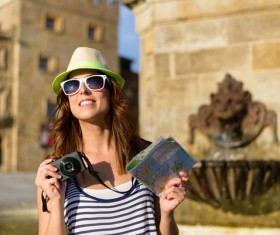 Woman tourist holding a camera and map Stock Photo